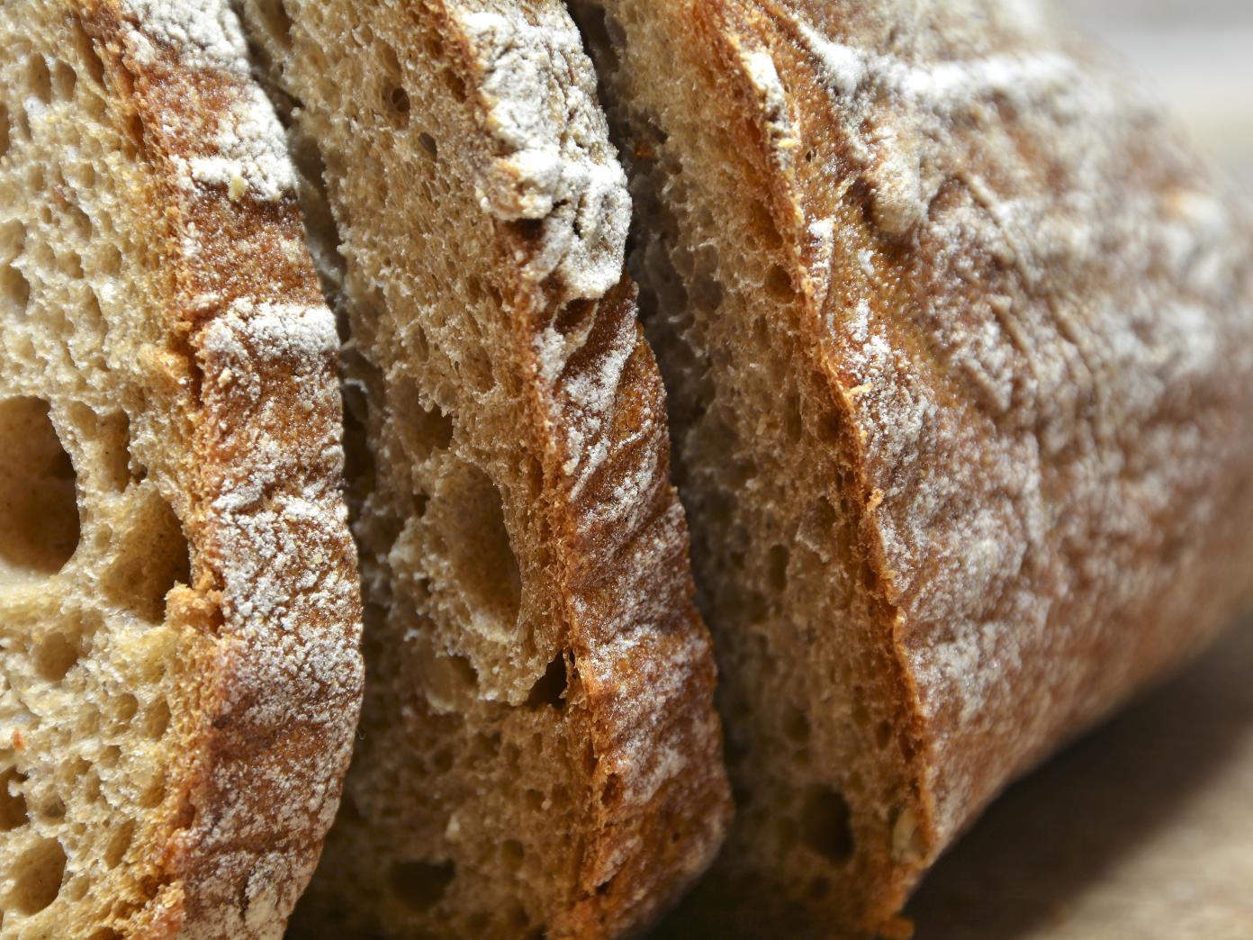 Nærbillede af franskbrød drysset med mel og skåret i skiver.